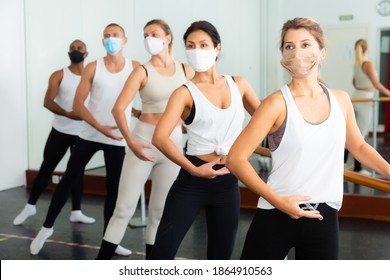 Ballet troupe in protective masks rehearses in a ballet class