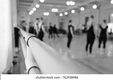 The ballet troupe rehearses in a ballet class against the backdrop of a ballet or barre