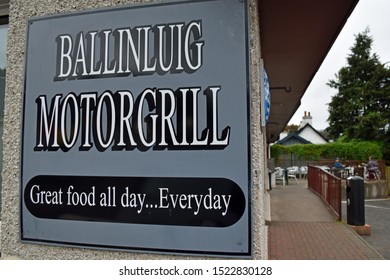 Ballinluig, Scotland/UK - October 5 2019: Sign For Ballinluig Motor Grill, Which Is A Famous Café/truck Stop On The A9 Road In Scotland, Blurred People Sitting Outside The Café In The Background