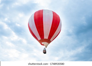 Balloon in the blue sky. Red balloon in the blue cloudy sky.