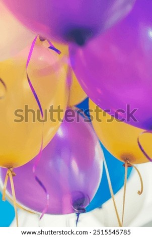 Balloon in Happy birthday party room background with string and ribbon (yellow, blue, violet, purple) helium Ballon floating in celebrate wedding day.Balloon in wedding and birthday party concept.