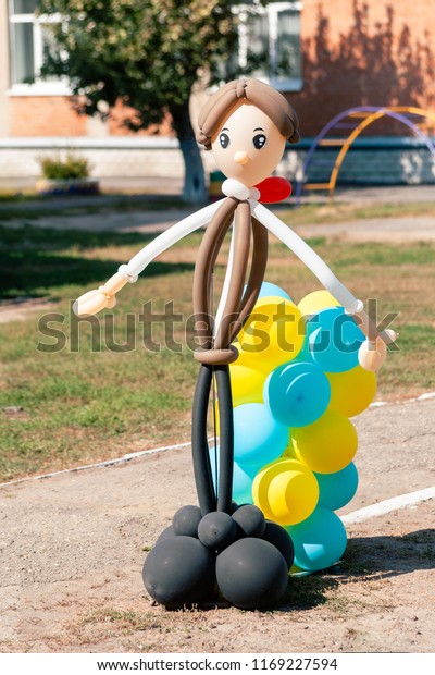 Balloon\
man dolly in the summer sun on the school\
garden