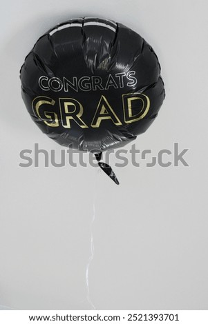 A balloon on the ceiling that says 