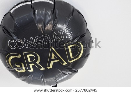 A balloon on the ceiling that says 