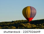 Balloonists in a balloon basket against the sky in summer.