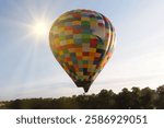 Balloonists running after another hot air balloon in a serene sky