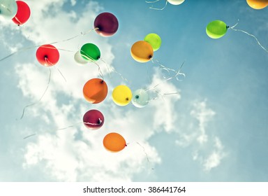 Balloons On Cloudy Sky