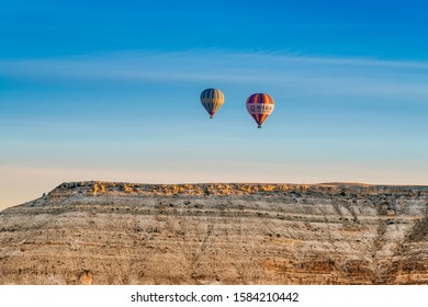 Balloons over the mountains on sunrise, 23 March 2019, Cappadocia, Turkey.