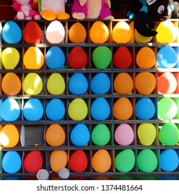 Balloons And Prizes At A Dart Throwing Game Booth At A Carnival, Fair, Or Amusement Park