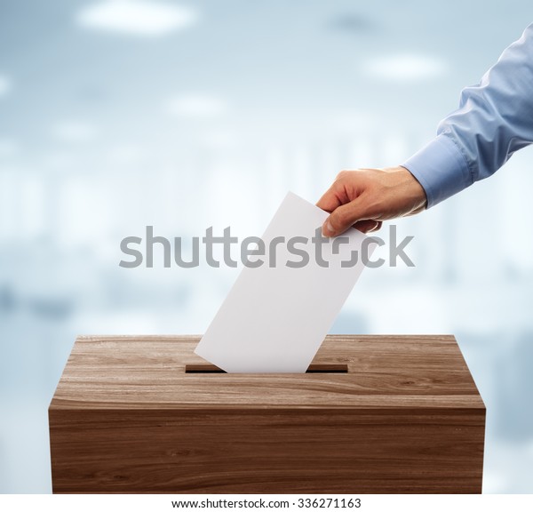 Ballot\
box with person casting vote on blank voting\
slip