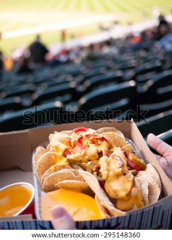 Ballpark Nachos Tray - Picture of person holding a tray of nachos at a ballpark sports event