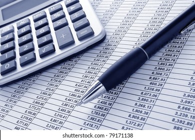 Ballpoint Ink Pen And Calculator On A Financial Spreadsheet Statement With Columns Of Numbers For An Accounting Budget Finance Reconciliation