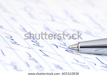 Ballpoint pen on a handwritten sheet of paper.