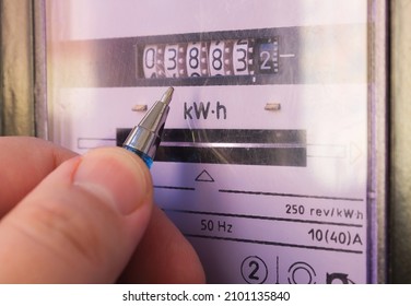 Ballpoint pen showing electricity meter readings. Distribution of electricity in an apartment building, payment of utility services. - Shutterstock ID 2101135840