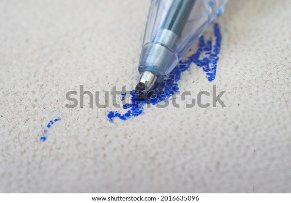 Ballpoint pen tip, scribbling on a white leather\
sofa, or car seats.