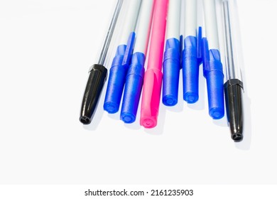 Ballpoint pens. Choice of handles. Colored pens. Ink pens for writing. The pens are on the page of the notebook. Stationery concep