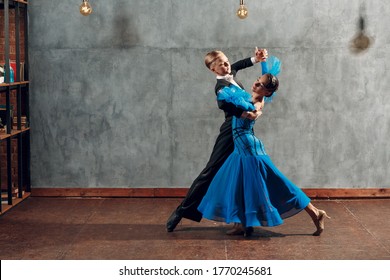 Ballroom dancing. Young pair dances waltz in studio.