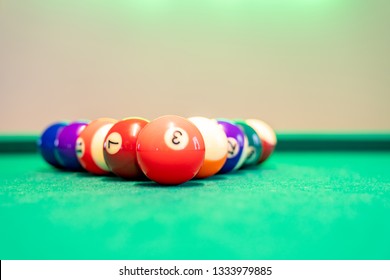 Balls lying on a pool table in a modern IT office.