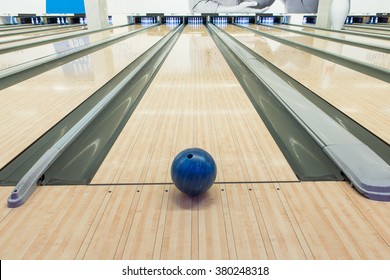 Balls on bowling alley against ten pins 