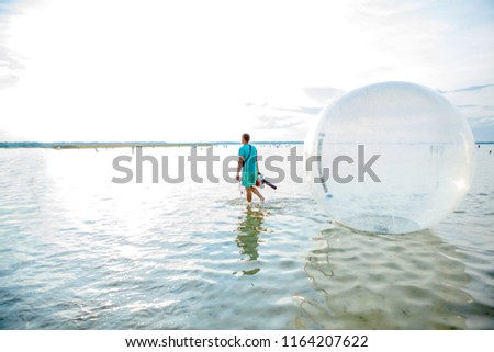 Balls on the water. Water balloons is a popular attraction with a ball on the water, allowing an adult or child to spend some time inside a large transparent sphere