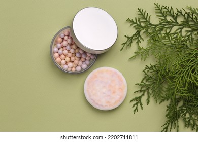 Balls Powder With Fir Sprig On Green Background. Natural Cosmetics Concept. Top View