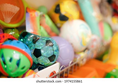 Balls Sitting On A Shelf In Toy Store. Merchandise In Retail Store For Children 
