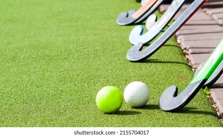 balls and sticks for field hockey lie on the grass - Powered by Shutterstock