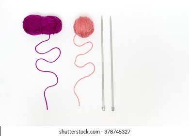 Balls Of Yarn With Knitting Needles Isolated On White