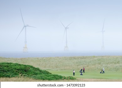 Balmedie, Aberdeen / Scotland, UK - 7th August 2019: Donald Trump Golf Course Showing Wind Farm Turbines And Golfers In The North Sea