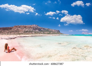 Balos lagoon on Crete island, Greece. A girl on a beach with pink sand. - Shutterstock ID 608627387