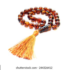 Baltic amber islamic rosary isolated on white 