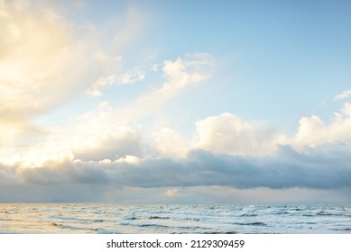 Baltic sea after the storm. Dramatic sky, glowing clouds, soft sunlight. Waves, splashing water. Picturesque scenery, seascape, nature. Panoramic view - Powered by Shutterstock