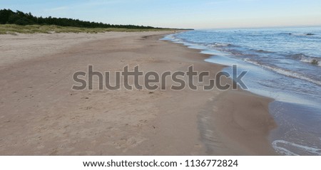 Baltic Sea beach with water, sand and sky. 
