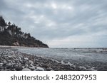 Baltic sea coastal line shoreside wide angle view. Photo taken on a cloudy autumn day in Latvia, Baltic.Scandinavia style.