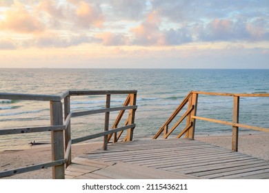 Baltic Sea Shore (beach) After The Storm. Sunset. Modern Wooden Walkway (boardwalk). Aerial View. Dramatic Sky, Waves And Water Splashes. Nature, Ecology, Ecotourism, Hiking, Recreation Concepts