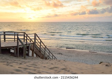 Baltic Sea Shore (beach) After The Storm. Sunset. Modern Wooden Walkway (boardwalk). Aerial View. Dramatic Sky, Waves And Water Splashes. Nature, Ecology, Ecotourism, Hiking, Recreation Concepts