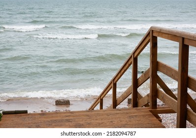 Baltic Sea Shore (beach) After The Rain And Storm. Modern Wooden Walkway (boardwalk). Waves And Water Splashes. Nature, Ecology, Eco Tourism, Hiking, Recreation Concepts