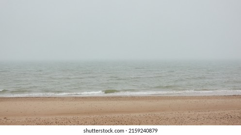 Baltic sea shore in a thick fog. Beach, sand dunes. Rainy day, gloomy sky, soft sunlight. Seascape. Nature, environment, vacations, ecotourism, walking, exploring concepts. Panoramic view - Shutterstock ID 2159240879