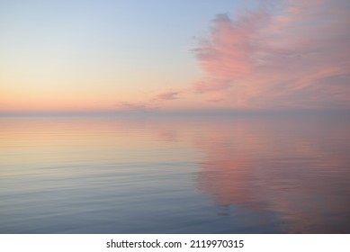 Baltic sea at sunset. Clear sky, blue and pink glowing clouds, soft golden sunlight. Water surface texture. Picturesque dreamlike seascape, cloudscape, nature. Panoramic view - Powered by Shutterstock