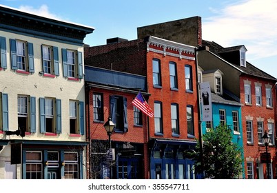 Baltimore, Maryland - July 22, 2013:  18th and 19th century brick houses line the Thames Street waterfront and house trendy shops, pubs, and restaurants at historic Fells Point