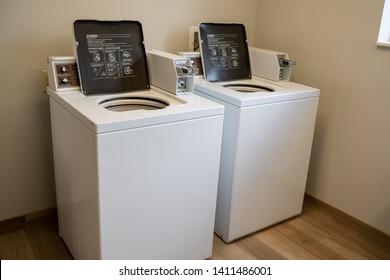 Baltimore, Maryland - May 14, 2019: Two Commerical Size Laundry Washing Machines, Coin Operated, In A Hotel Laundry Room Used By Guests