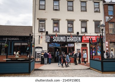 Baltimore, Maryland US - April 9, 2022: Facade and exterior of local business Sound Garden new and used record and vinyl music store on Thames st in Fells Point with people walking on the sidewalk