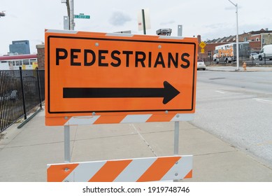 Baltimore, Maryland US - February 06, 2021: Pedestrian Sidewalk Detour Metal Sign On Wood Board, Walkway Closed So Walkers And People Must Cross The Street Around Road Construction Site Downtown