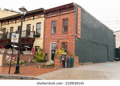 Baltimore, Maryland US - February 24, 2022: Exterior of historic townhouse building that is home to local business Saints and Sinners Tattoo shop along Thames street in Fells Point
