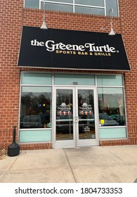 Baltimore, Maryland / US - March 11, 2020: Awning And Brick Storefront Of Local Regional Restaurant Bar Pub Chain Greene Turtle Glass Entrance Doors Open For Small Business During Covid-19 Pandemic