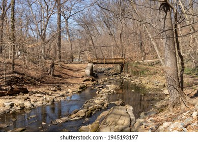 Baltimore, Maryland US - March 19, 2021: A Manmade Bridge Straddles A Tall Crossing Of Stoney Run, A Freshwater Stream That Empties Into The Patapsco River In The Chesapeake Bay Watershed