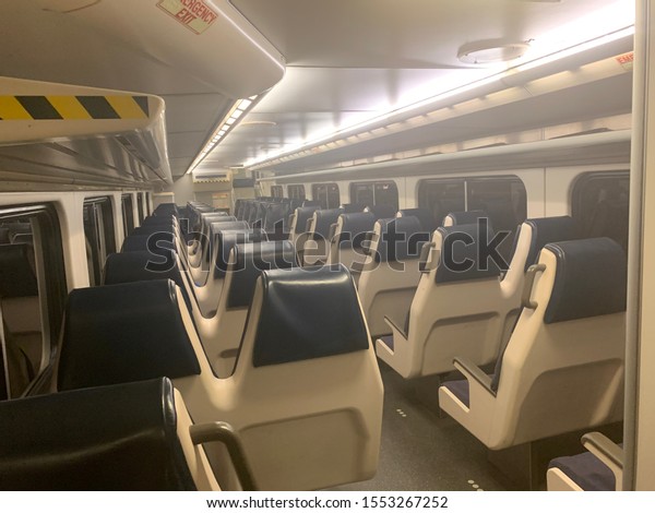 Baltimore, Maryland / US - Nov 4, 2019: Night time,\
empty interior lower level of MARC train double deck passenger cars\
with lights on and empty\
cabin