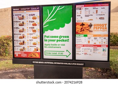 Baltimore, Maryland US - November 12, 2021: Now Hiring Help Wanted On Digital Signage Of Burger King Fast Food Franchise Apply Now On Menu Board Car Lane Of Suburban Restaurant Drive Thru