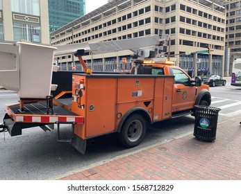 Baltimore, Maryland / US - November 23, 2019: Baltimore Orange Electrical Utility Truck Parked In An Intersection Essential City Employee Worker Response To Repair A Broken Street Traffic Signal