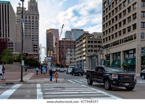 Baltimore,\
Maryland, USA - July 11, 2017: Pedestrians crossing in a crosswalk\
in downtown Baltimore near the city\
center.